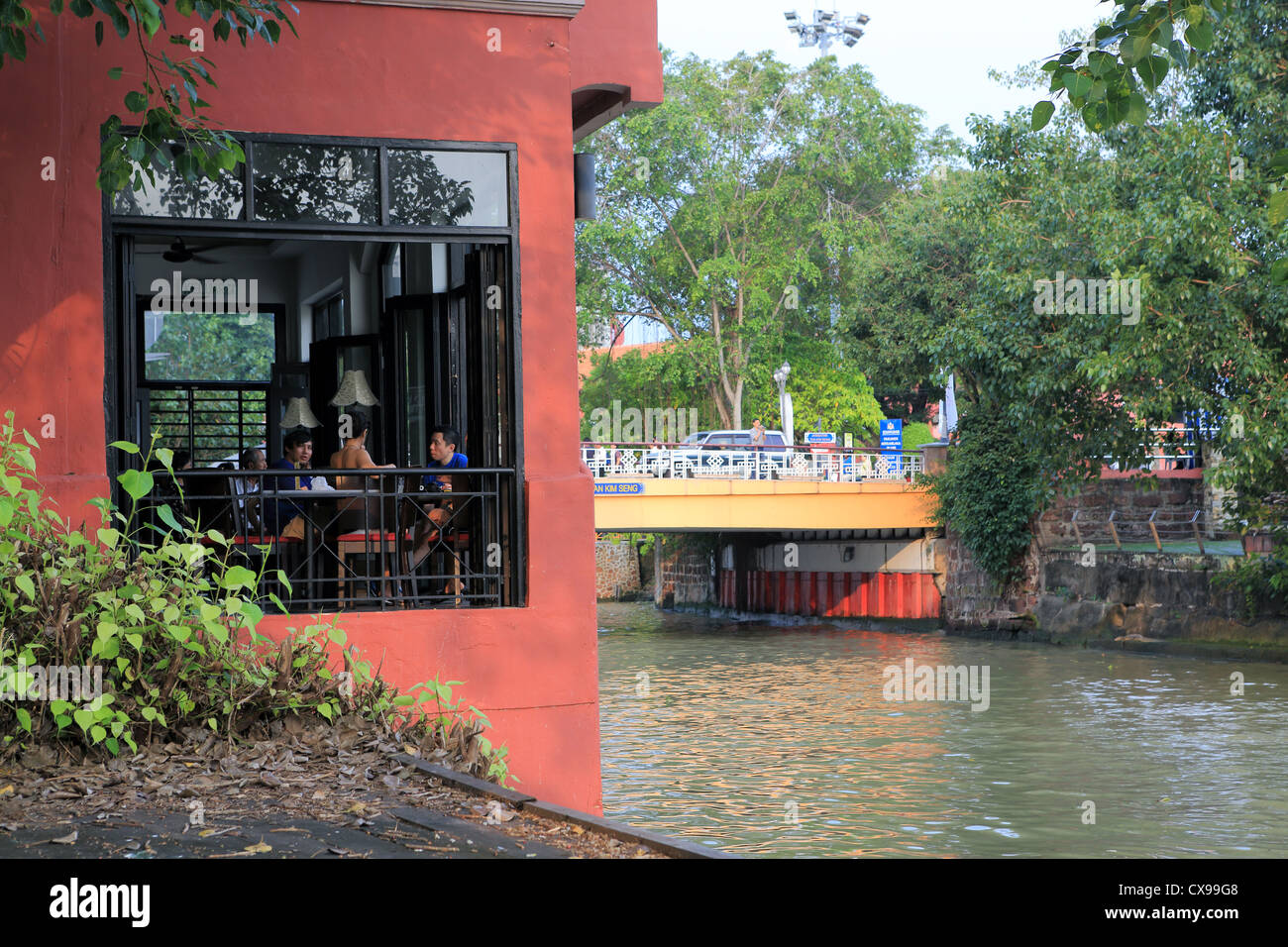 Les gens de dîner dans un restaurant au bord de la rivière avec vue sur la rivière Melaka en Melaka. Banque D'Images