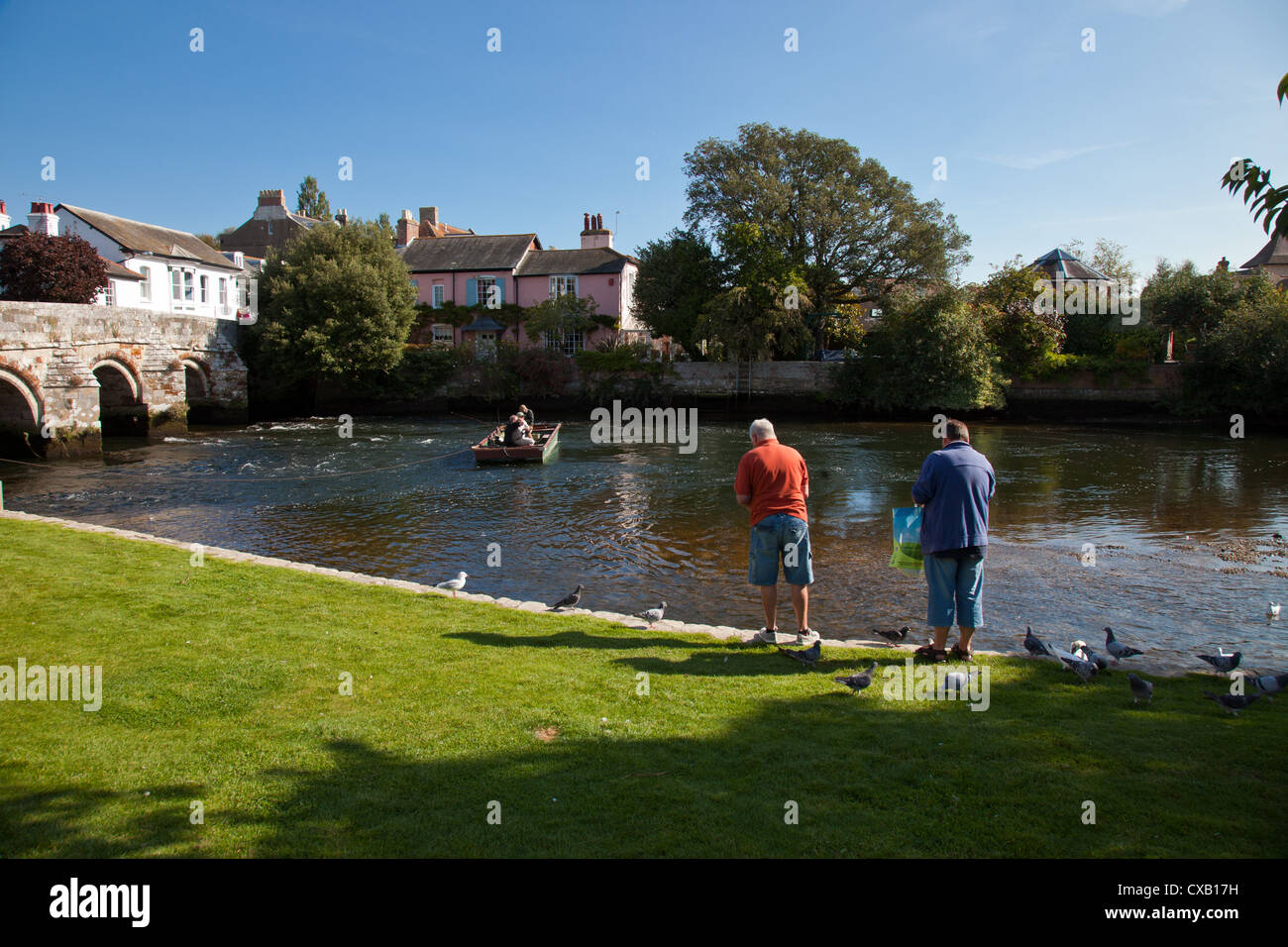 Trois hommes dans un bateau de pêche sur la rivière Avon à Christchurch Dorset England UK. Banque D'Images