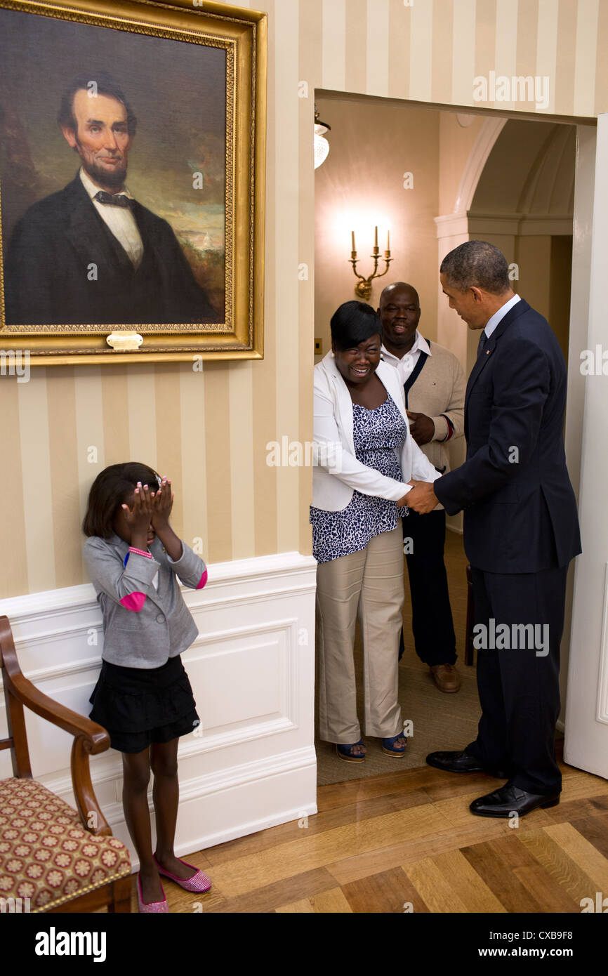 Huit ans de l'enfant réunion Janiya Penny réagit après le président américain Barack Obama qu'il se félicite de sa famille le 8 août 2012 pour le bureau ovale à la Maison Blanche. Banque D'Images