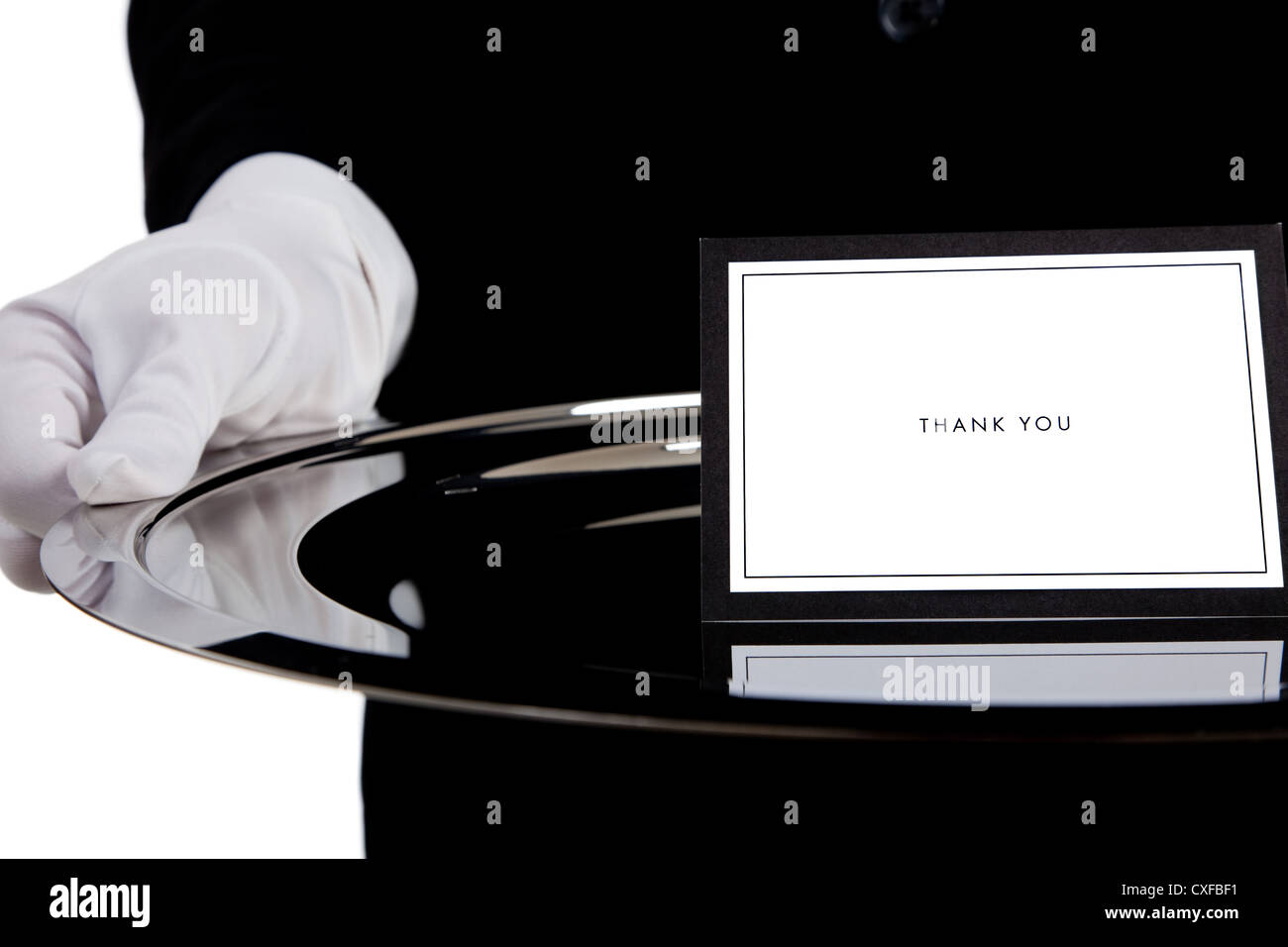 White gloved hand holding a silver tray avec une carte de remerciement Banque D'Images