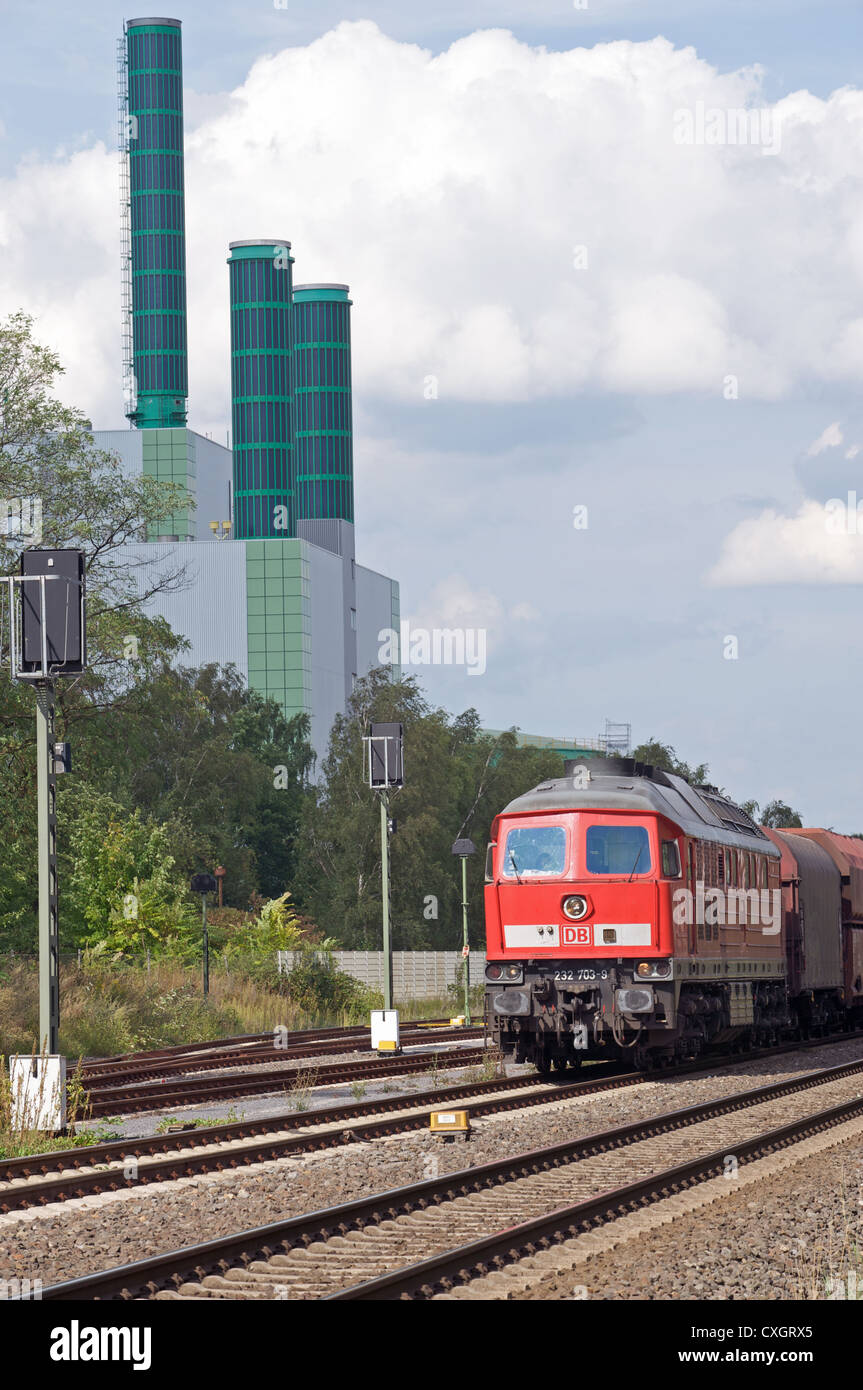 Train de marchandises et de la gare centrale au gaz avec panneaux solaires installés sur les cheminées d'usines Banque D'Images