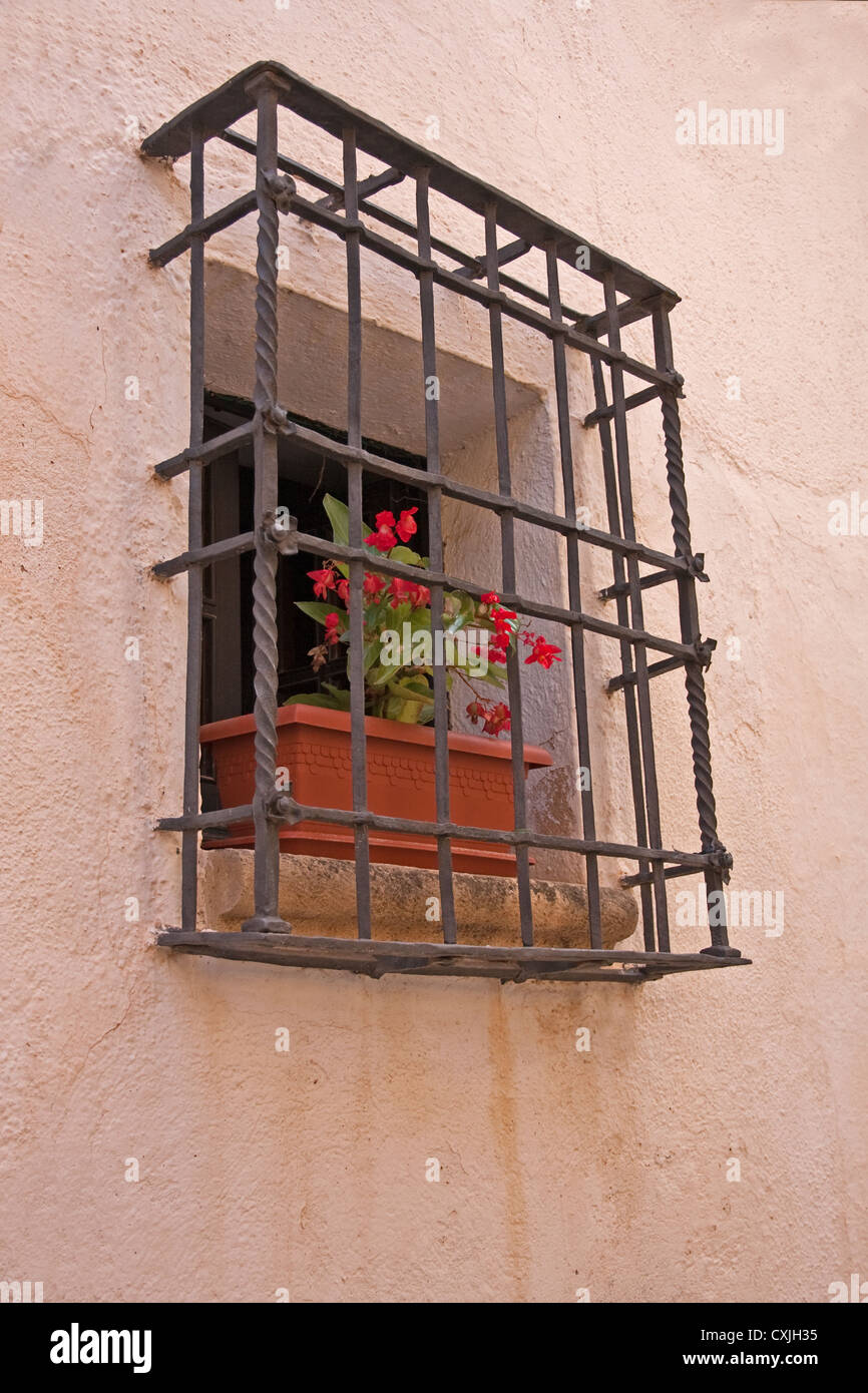 La fenêtre ouverte avec les bégonias rouges croissant dans le semoir sur rebord de fenêtre dans mur de la maison, altafulla, Espagne Banque D'Images