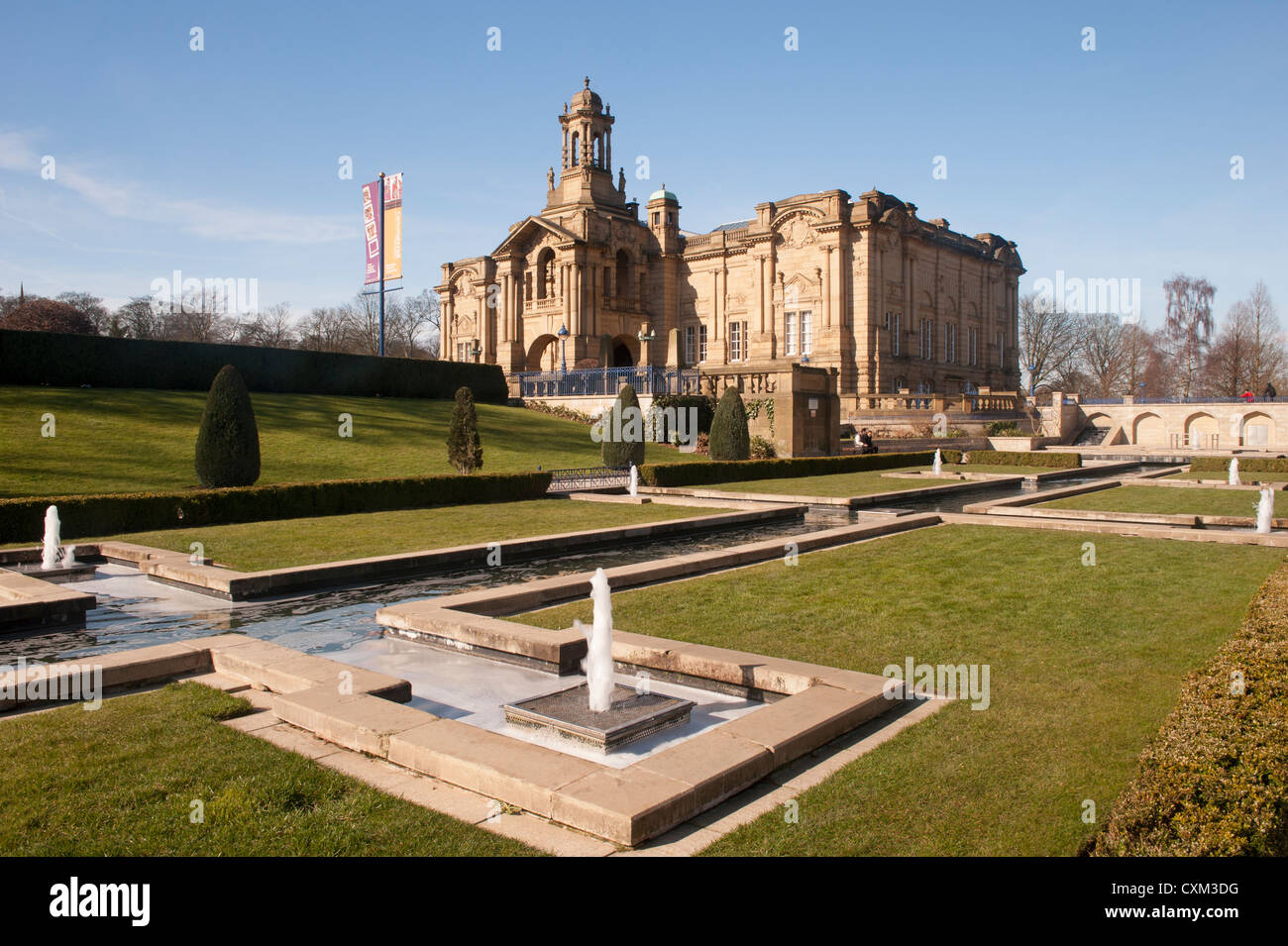 Extérieur de la galerie d'art civique de Cartwright Hall ensoleillée (grand bâtiment historique du musée) et fontaines de jardin aquatique Mughal - Lister Park, Bradford, Angleterre Banque D'Images