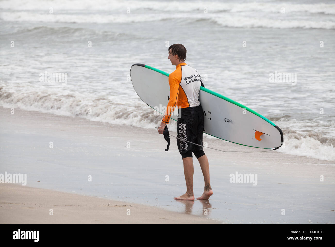 Surfer sur la plage de Kuta à Bali Banque D'Images