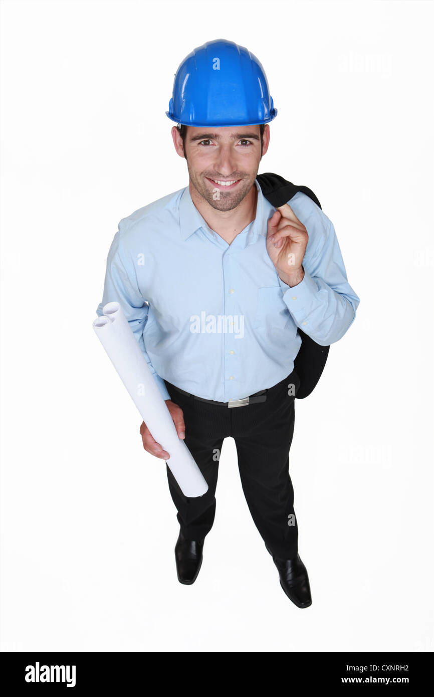 Ingénieur en souriant tenant un tapis d'encombrement Banque D'Images