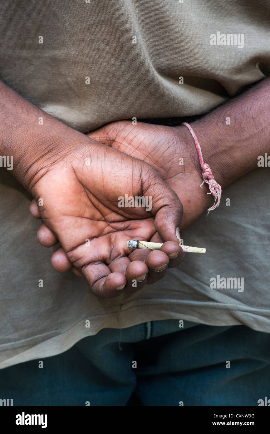 Indian man holding a allumé Indian beedi dans sa main. L'Inde Banque D'Images