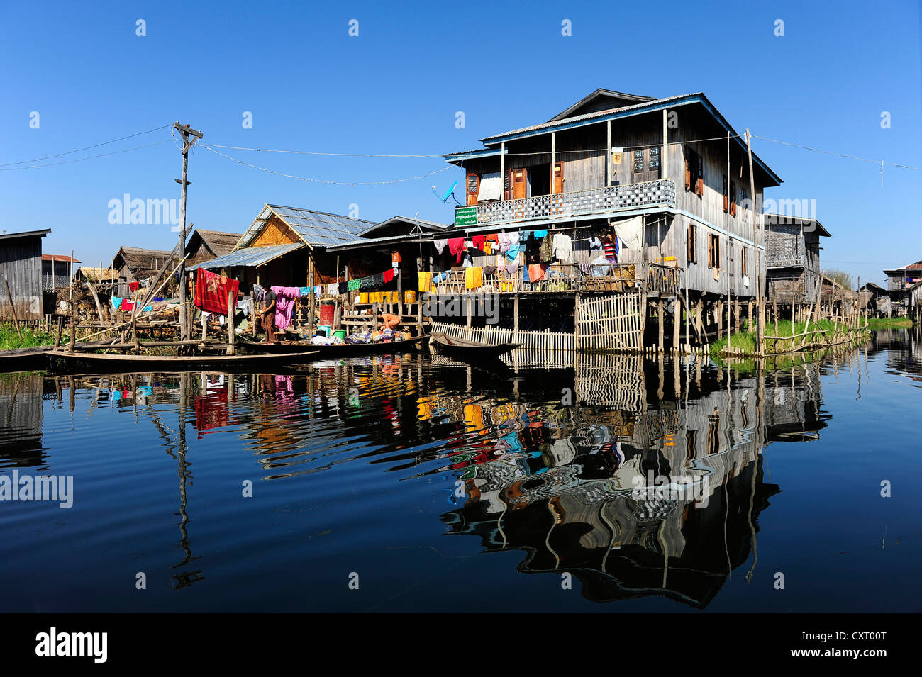 Des maisons sur pilotis avec des réflexions sur le lac Inle, en Birmanie aussi connu sous le nom de Myanmar, en Asie du Sud-Est, l'Asie Banque D'Images
