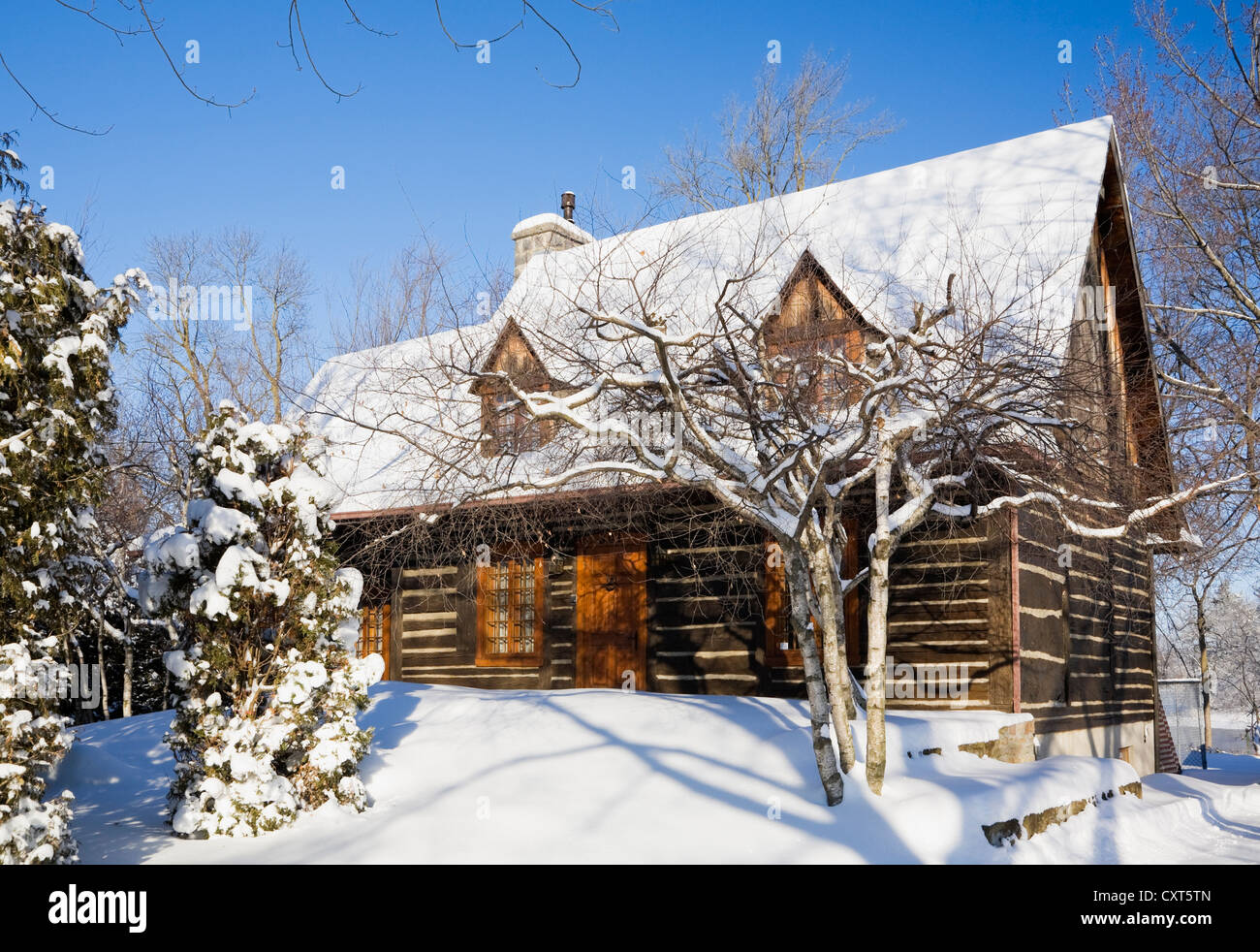 Ancien de style cottage Canadiana reconstruit log home résidentiel, 1975, en hiver, au Québec, Canada. Cette image est libéré de la propriété Banque D'Images