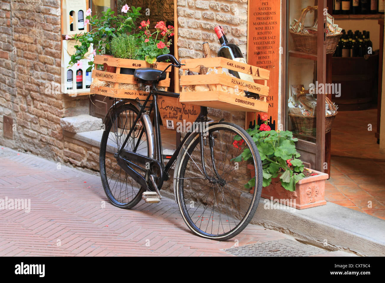 Vieux vélo avec des caisses de vin en face d'une boutique de vins, San Gimignano, province de Sienne, Toscane, Italie, Europe Banque D'Images