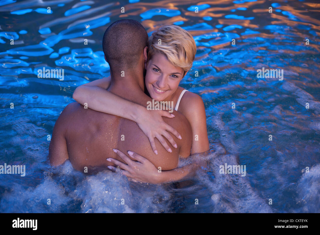 Couple relaxing in jacuzzi intérieur Banque D'Images