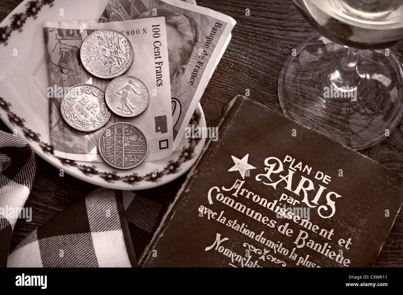 Concept 1950 1960 voyage français rétro, style Art déco à Paris guide book, en francs français, verre de vin sur la table de restaurant au soleil Banque D'Images