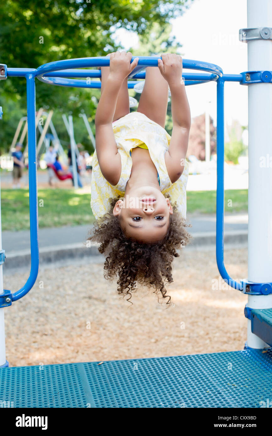 Mixed Race girl playing on playground Banque D'Images