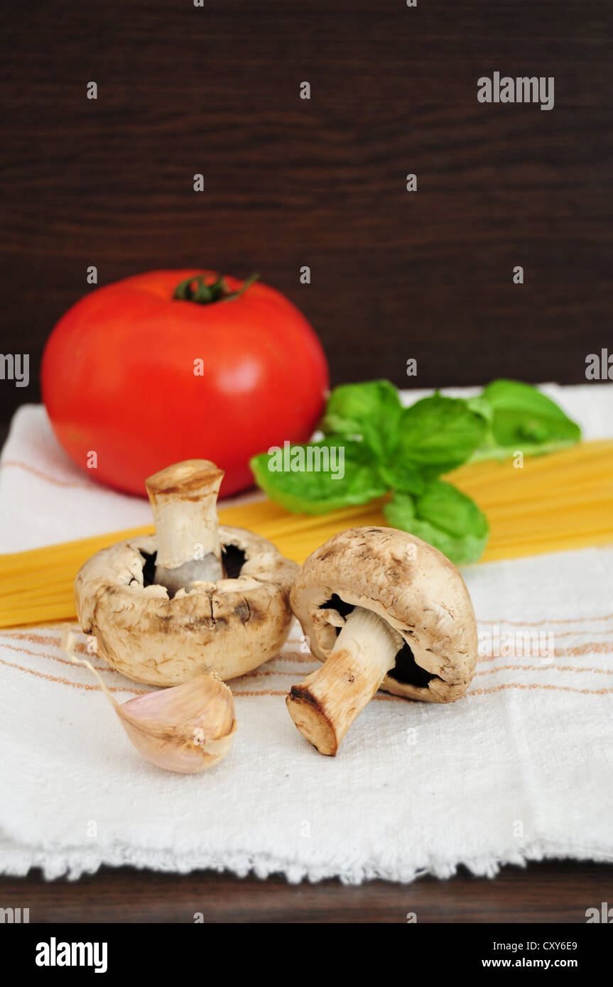 Ingrédients pour les pâtes - spaghetti, champignons, tomate, ail et basilic Banque D'Images
