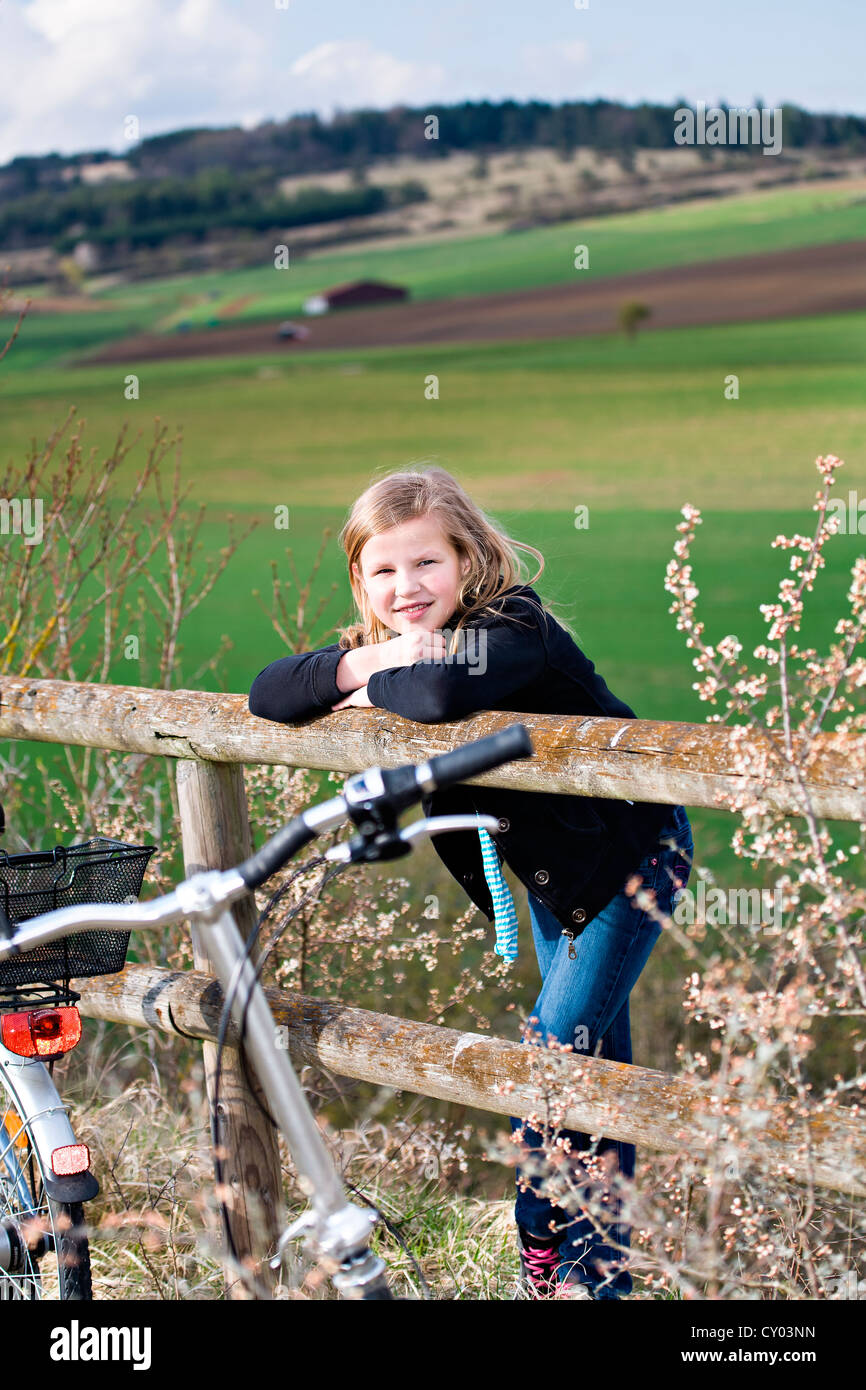 Fille avec son vélo en face du paysage rural Banque D'Images