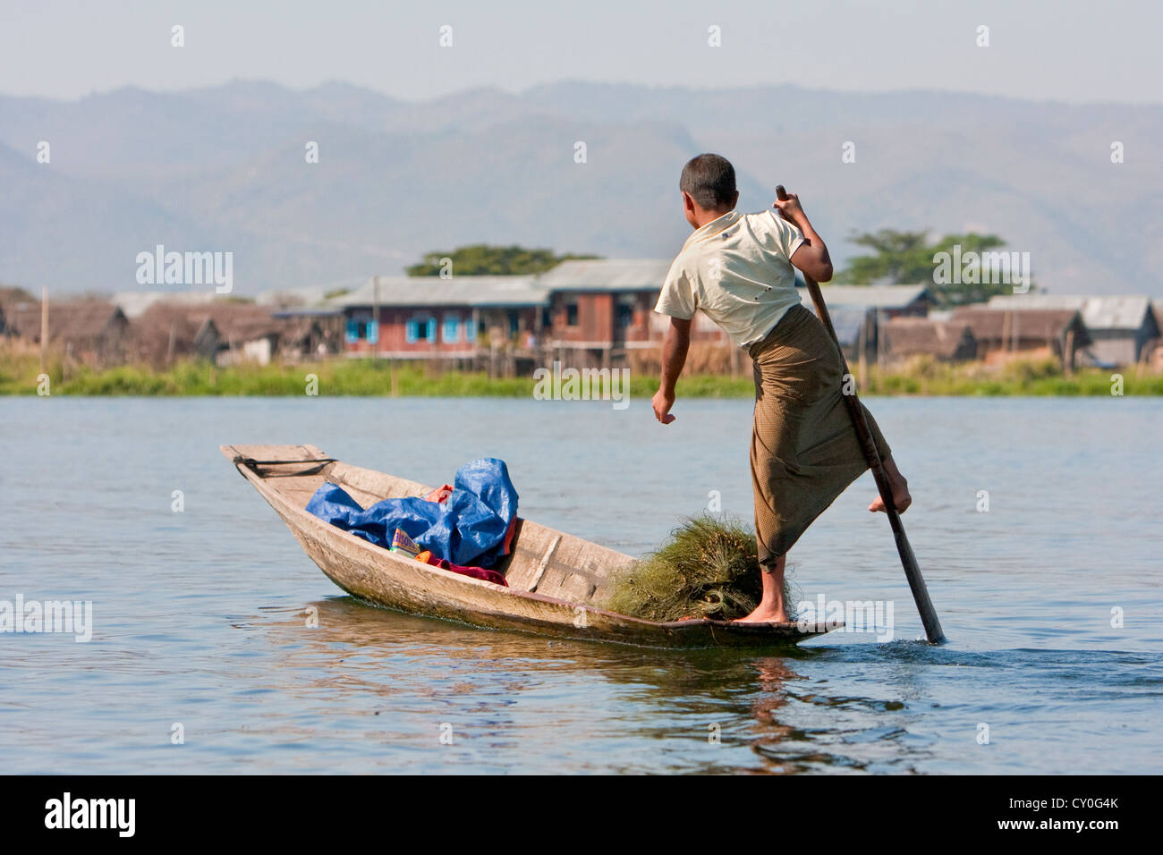 Le Myanmar, Birmanie. Jeune homme avec une jambe, dans le style commun à Lac Inle, l'État Shan. Banque D'Images