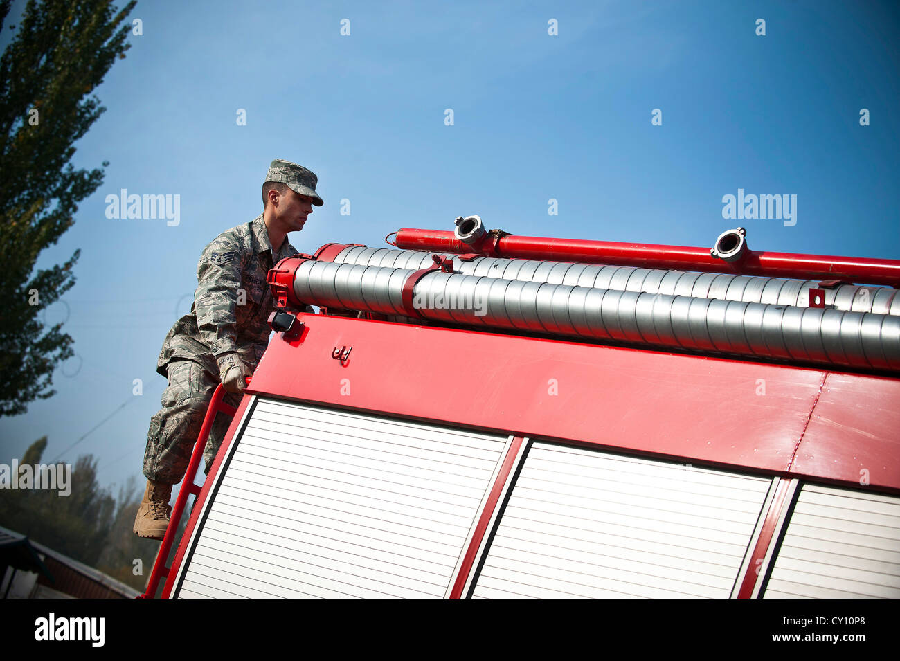 Airman senior adam preston monte sur un camion de pompiers République kirghize au cours d'une manifestation au centre de transit de manas, au Kirghizistan, oct. 16, 2012. La démonstration incluait une course à obstacles, répondant à un feu contrôlé et un équipement d'échanges d'informations entre les États-Unis et République kirghize pompiers. Preston est un 376e Escadron de génie civil expéditionnaires déployés à partir de pompier dyess Air Force Base, Texas. Banque D'Images