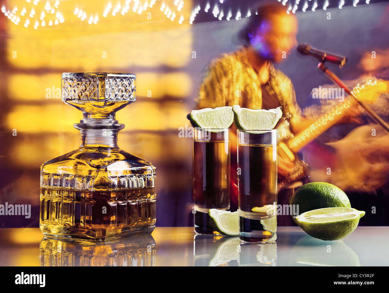 Tequila gold et de la chaux sur une table en verre en boite Banque D'Images