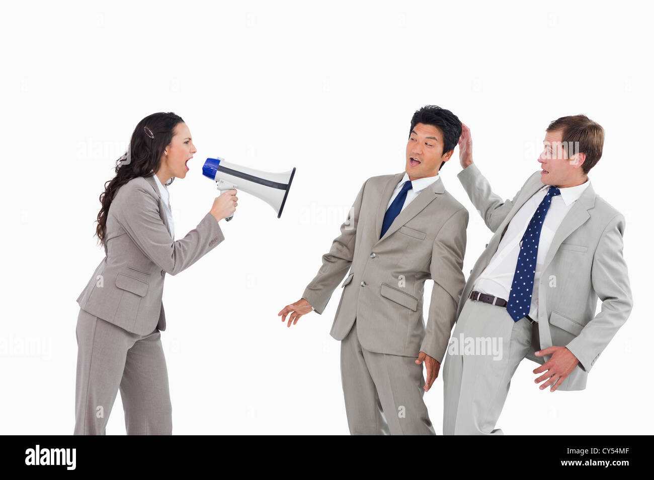 Businesswoman with megaphone yelling at collègues Banque D'Images