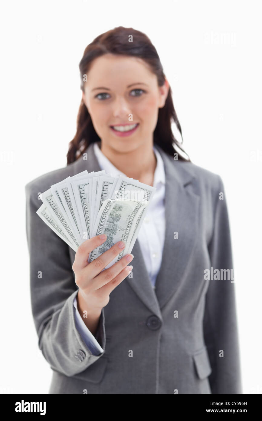 Businesswoman smiling and holding US dollar bank note Banque D'Images