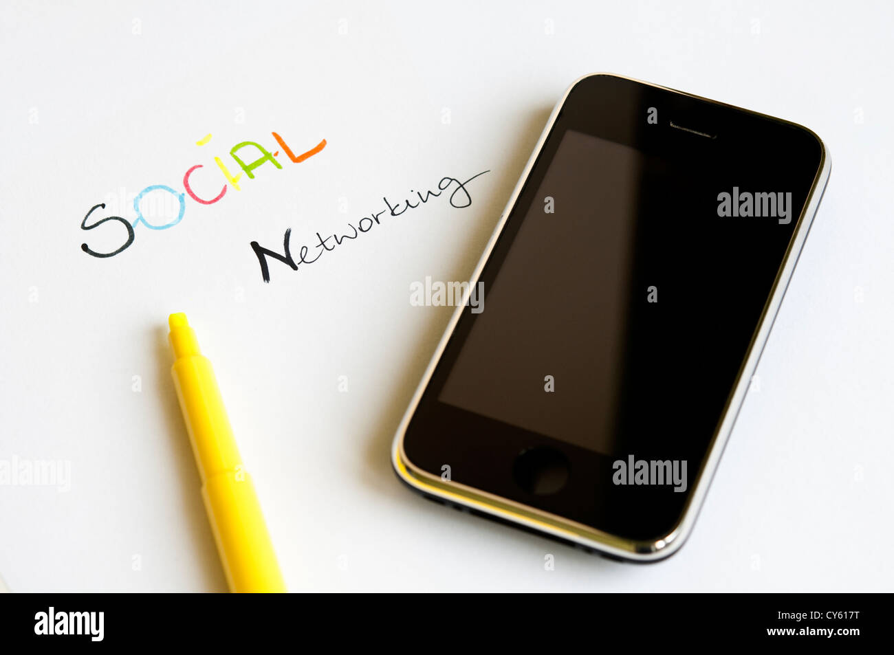Concept de réseau social avec des lettres colorées, écran tactile moderne téléphone mobile et surligneur jaune Banque D'Images