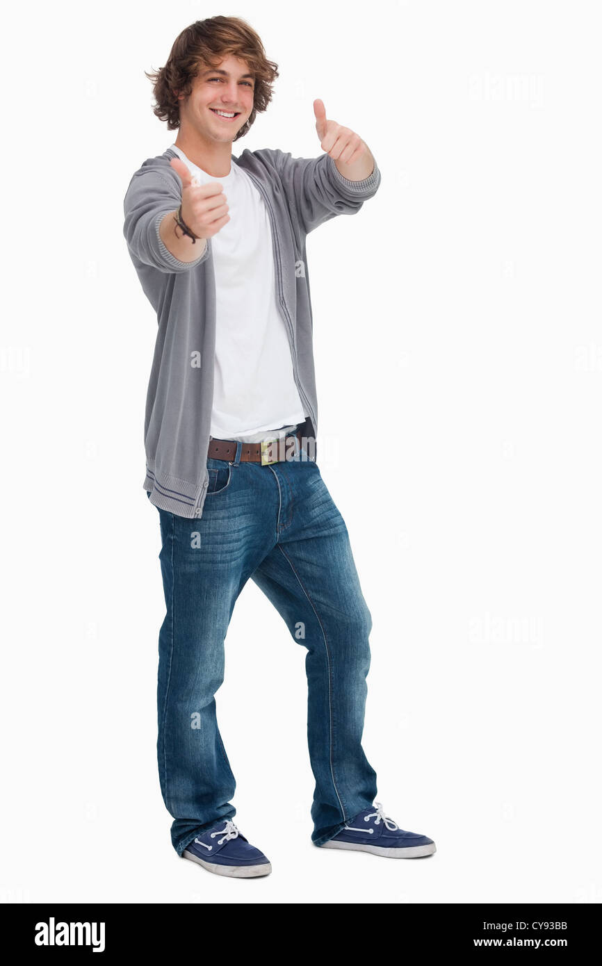 Smiling male student posing la thumbs-up Banque D'Images