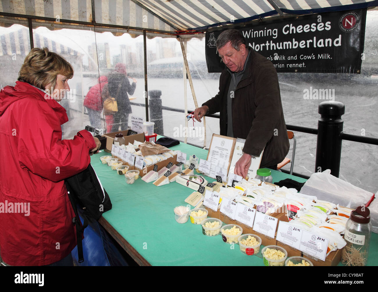 Vente de fromages à l'homme de Northumbrie sur un étal du marché Newcastle Quayside Angleterre du Nord-Est UK Banque D'Images