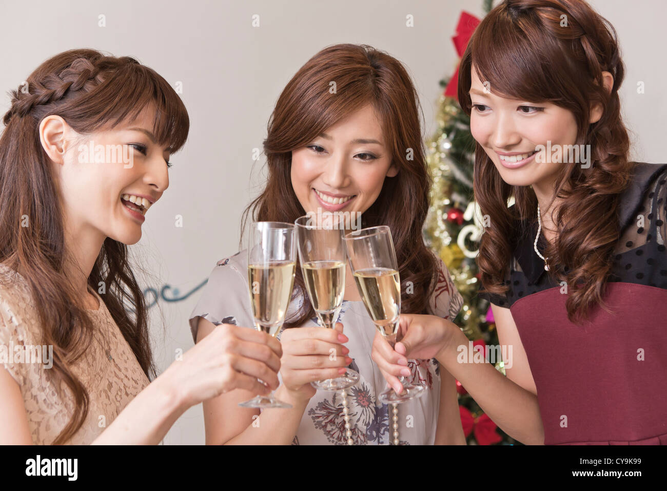 Trois jeunes femmes Toasting pour Noël Banque D'Images