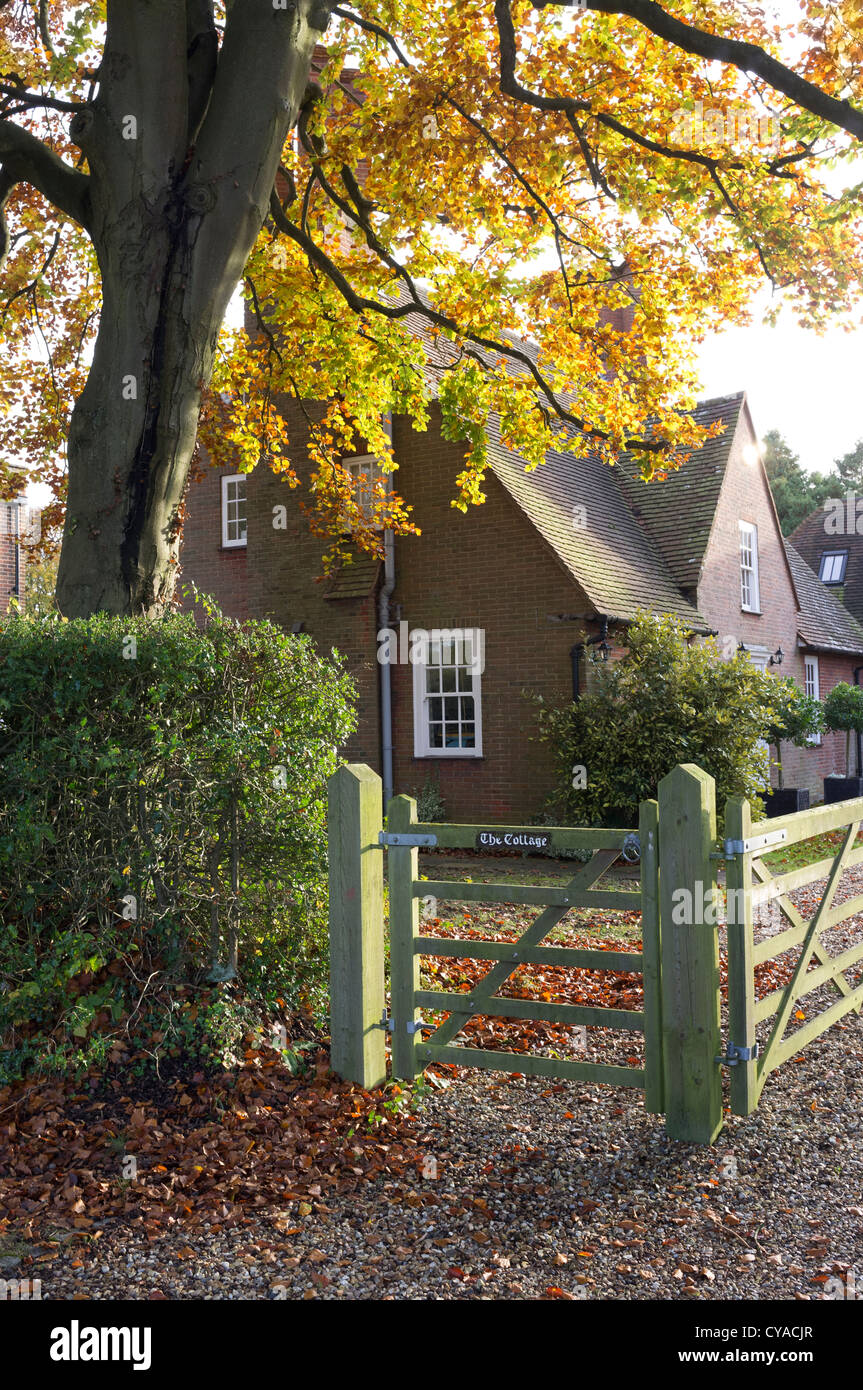 Un arbre en porte-couleurs de l'automne en plus d'une porte en bois d'un chalet en village Jordans Bucks UK Banque D'Images