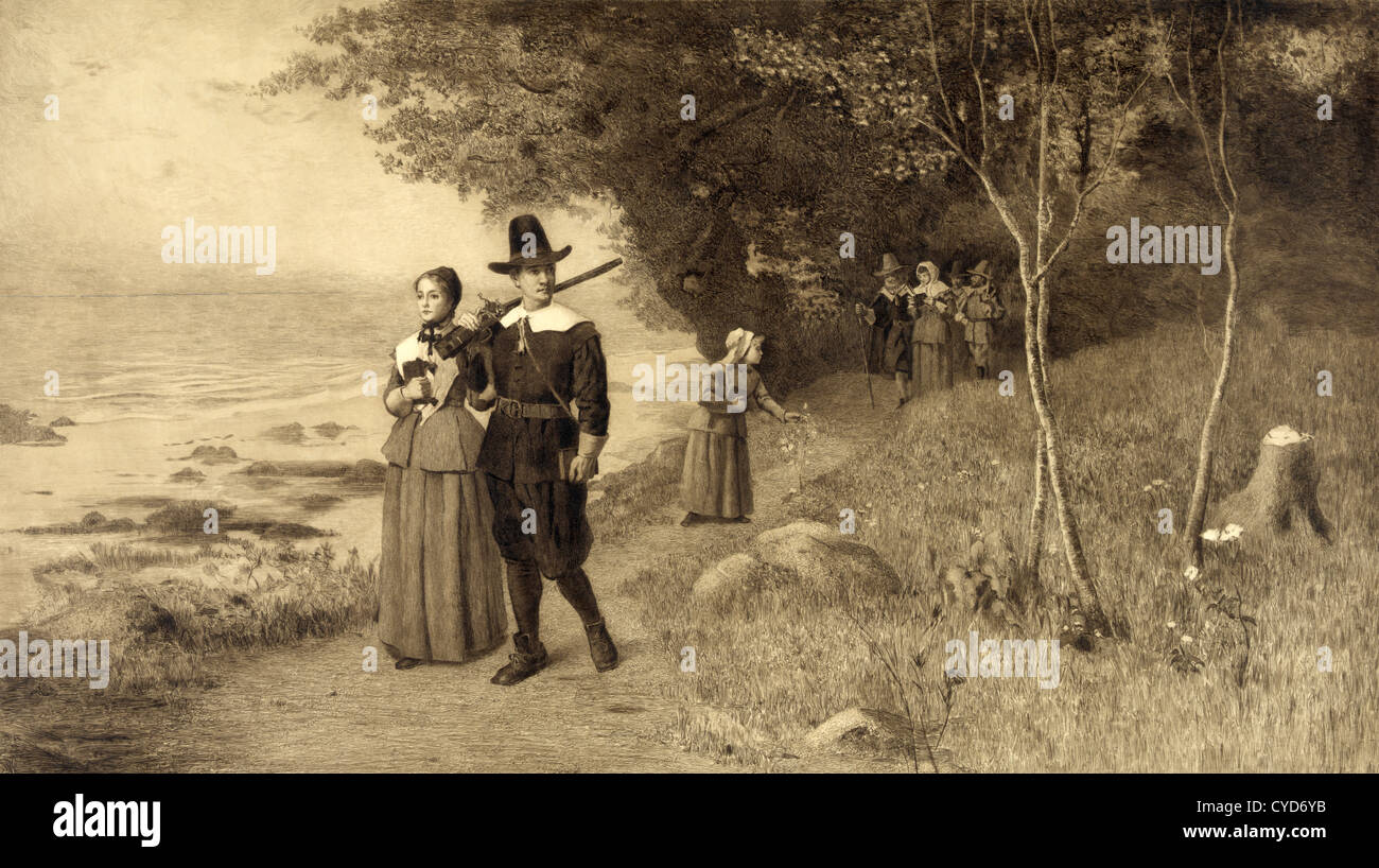 Pèlerins holding Bibles walking down path Banque D'Images