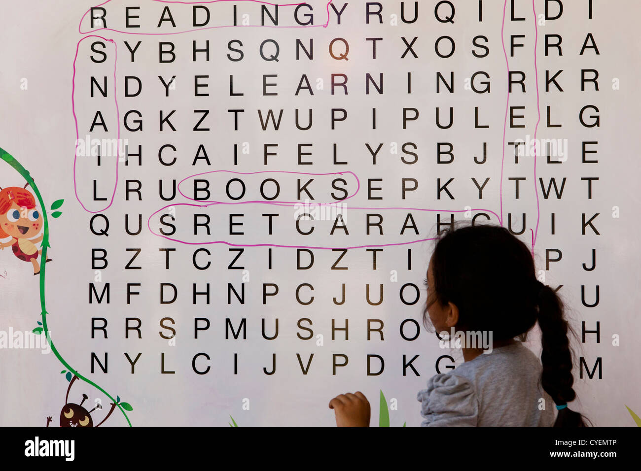 Jeune fille travaillant sur Word search puzzle Banque D'Images
