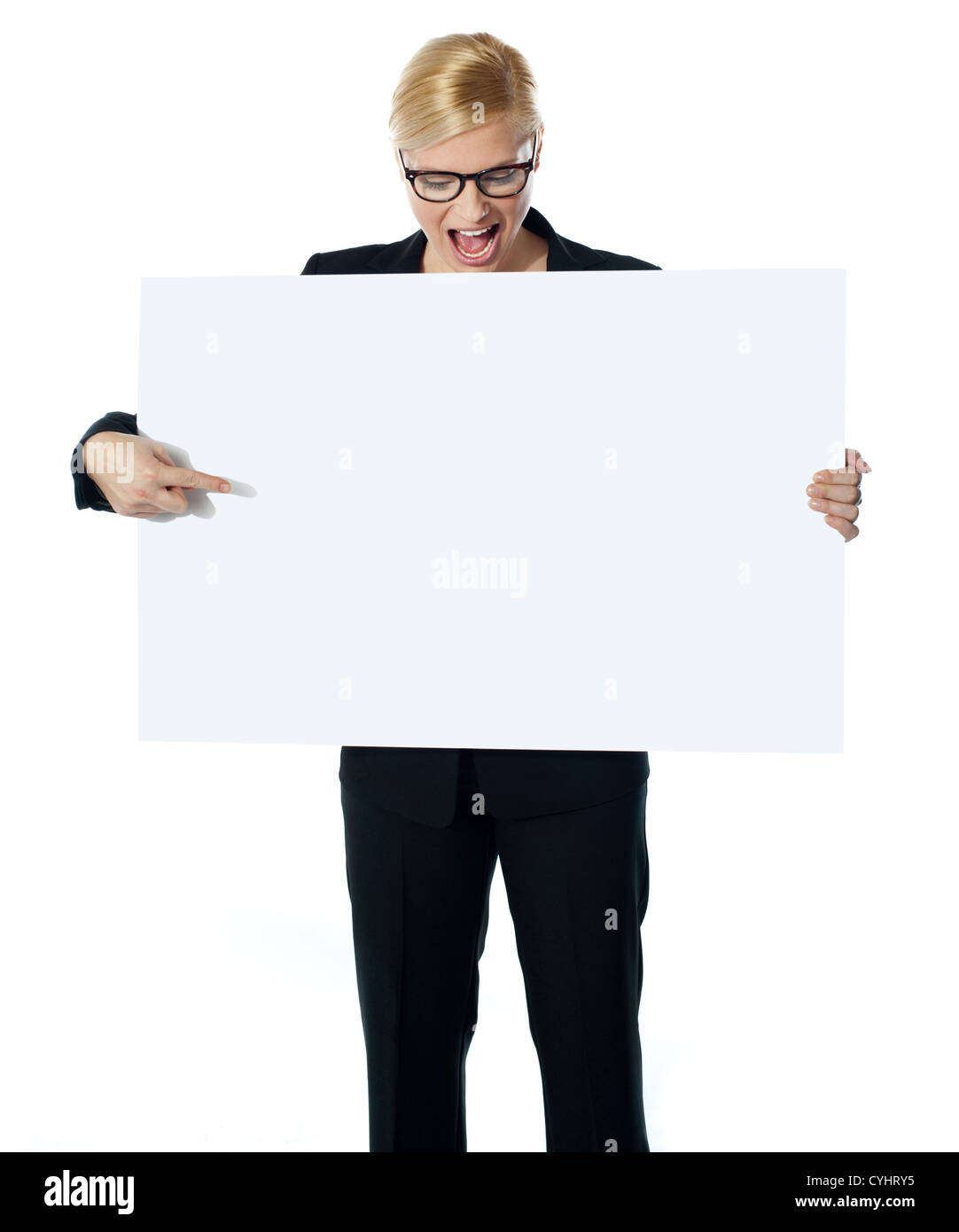 Femme d'affaires réussie pointing at white blank billboard. Regardant vers le bas Banque D'Images