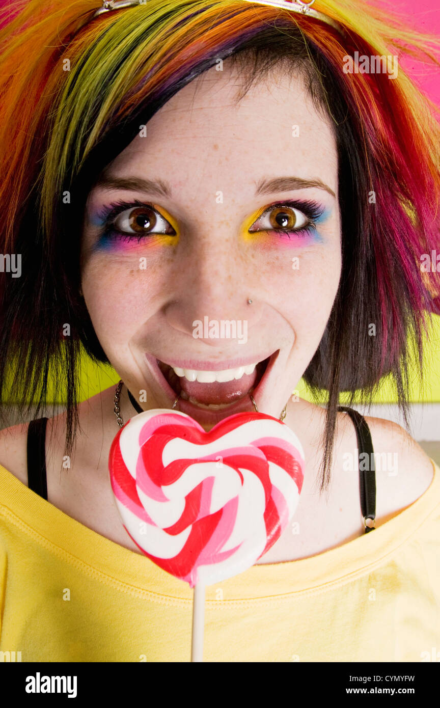 Autre fille dans une cuisine colorée avec un coeur Lollipop Banque D'Images