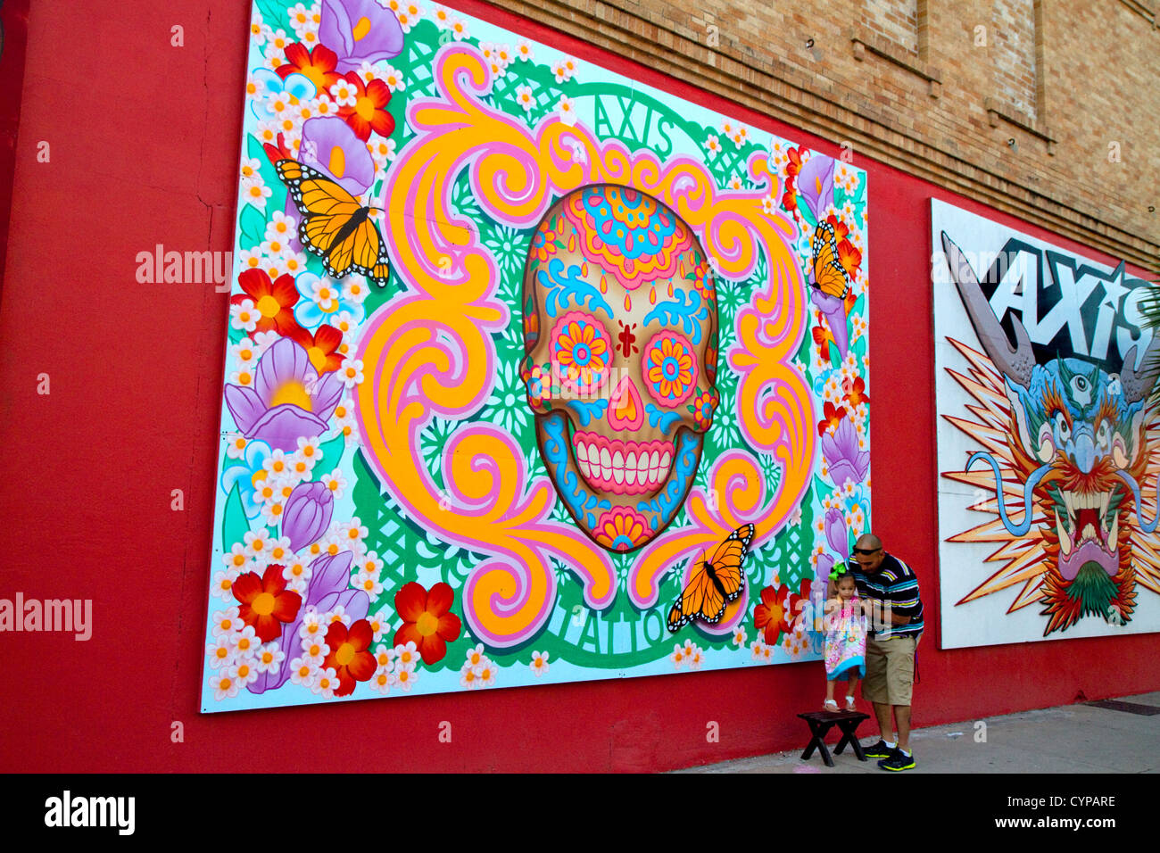 Peinture murale sur le côté d'un magasin de tatouage utilisé comme arrière-plan pour un portait de Corpus Christi, Texas, États-Unis. Banque D'Images