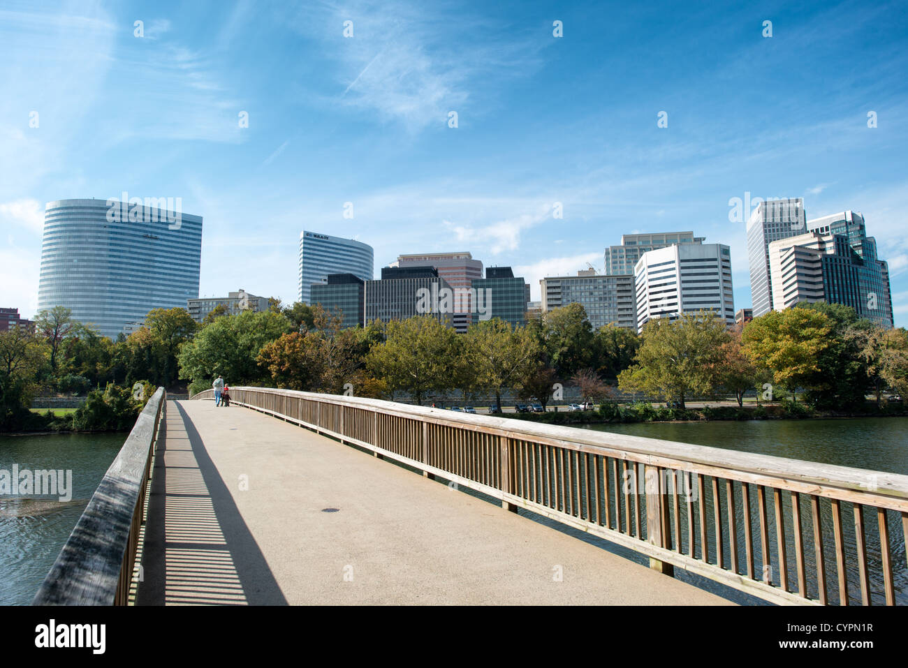 ARLINGTON, Virginie — la ligne d'horizon de Rosslyn s'élève bien en vue sur le fleuve Potomac, vue depuis le pont piétonnier reliant Roosevelt Island à la Virginie continentale. Rosslyn, le noyau urbain dense d'Arlington, comprend un groupe d'immeubles de bureaux modernes de grande hauteur et de tours résidentielles qui font partie de l'horizon de la zone métropolitaine de Washington, DC. Le pont piétonnier permet d'accéder à Roosevelt Island, un mémorial boisé de 88 acres dédié au président Theodore Roosevelt géré par le National Park Service. Ce point de vue offre l'une des vues distinctives du développement urbain de Rosslyn c Banque D'Images