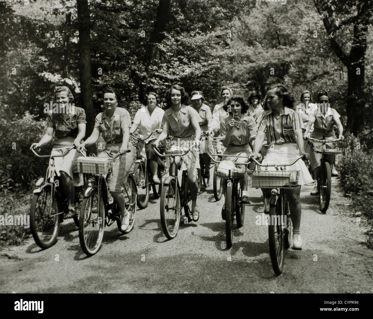 Groupe de femmes cyclistes sur route de terre, USA, 1950 Banque D'Images