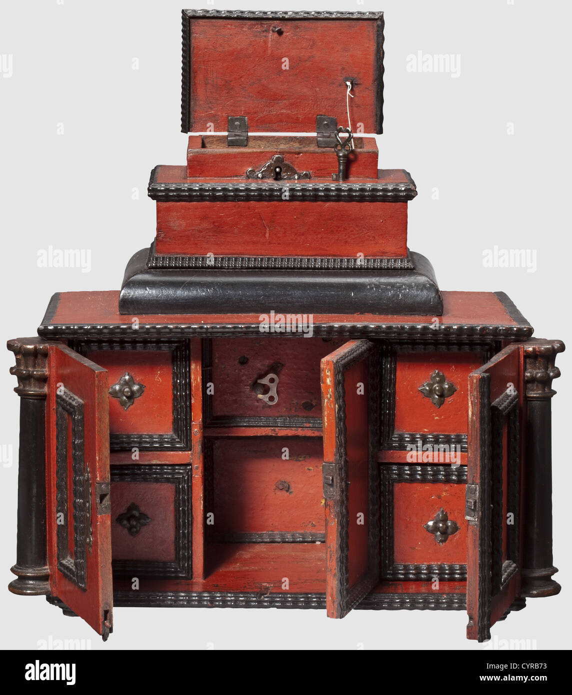 Une armoire miniature sud-allemande avec une boîte à musique, 1ere moitié  du 17ème siècle boîtier rectangulaire en noyer peint en rouge et noir,  richement taillé avec moulure ondulée, et avec deux demi-colonnes