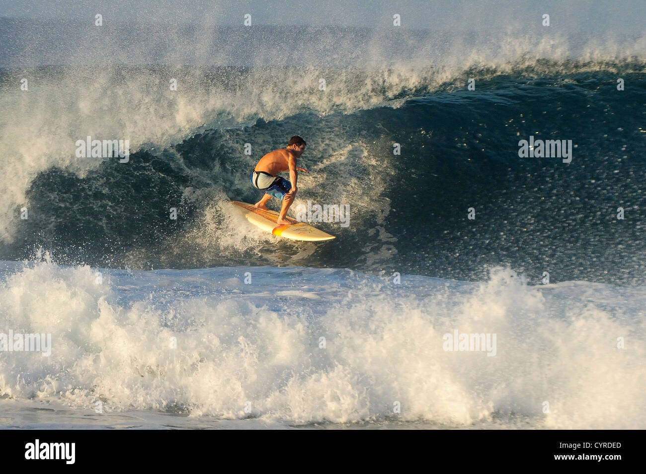 Mexique, Oaxaca, Puerto Escondido, seul surfer en action une vague déferlante d'équitation dans l'océan Pacifique beach resort. Banque D'Images