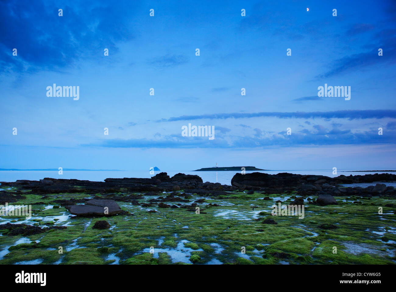 Vue depuis la plage de rochers à Kildonan à la recherche à travers l'eau vers l'Ailsa Craig et Pladda phare, Arran, Ecosse, Royaume-Uni Banque D'Images