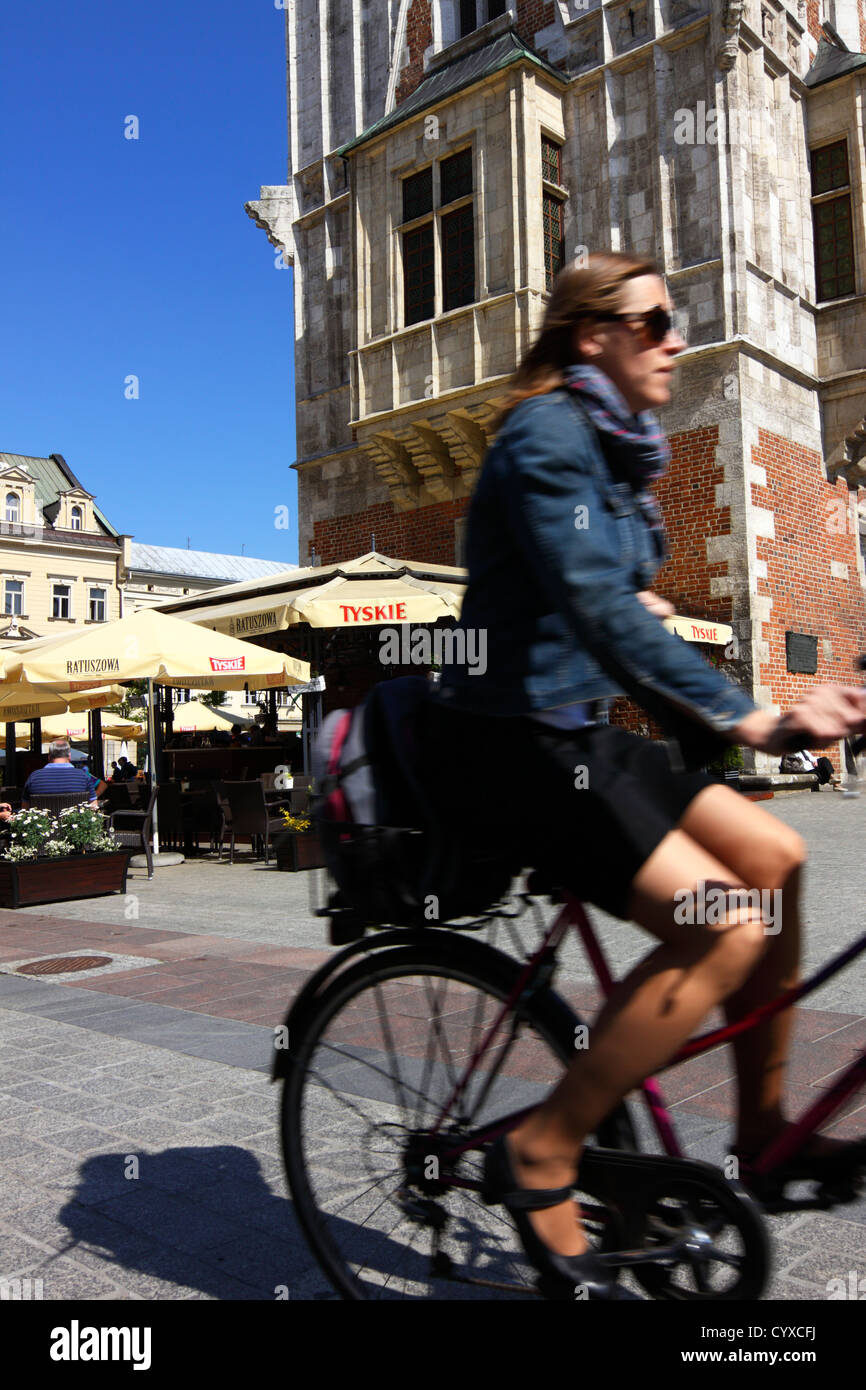 Femme avec minijupe et lunettes de vélo passé tour du vieil hôtel de ville  dans la place du marché. Cracovie, Pologne Photo Stock - Alamy