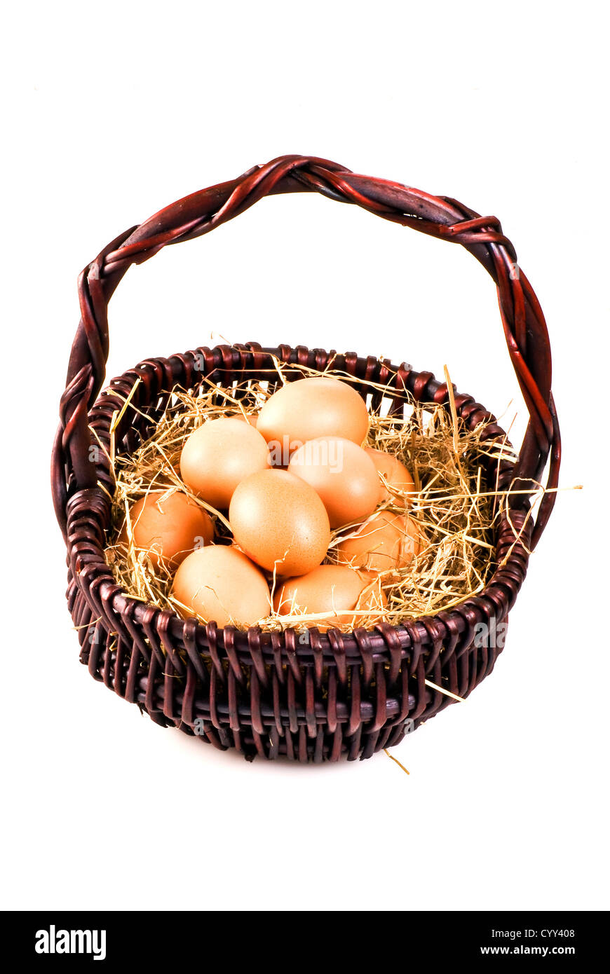 Oeufs de ferme frais dans le panier avec hay - isolé Banque D'Images