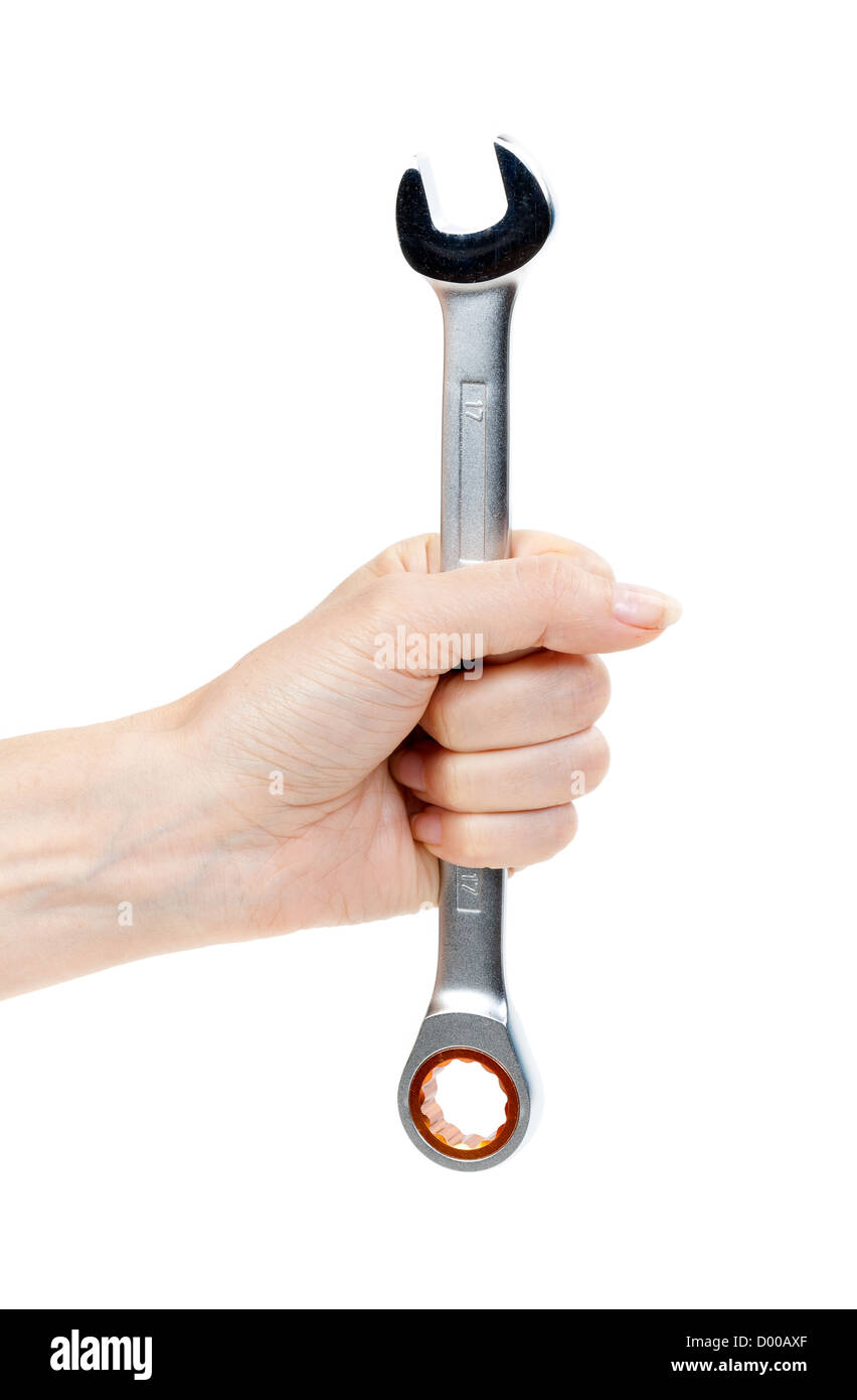 Woman's hand holding a chrome clé. Isoler sur blanc. Banque D'Images