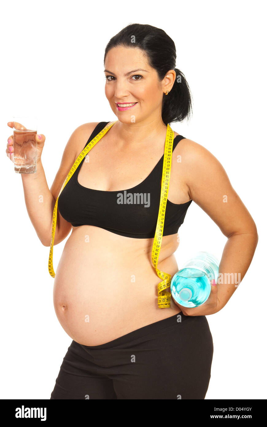 Happy pregnant holding glass avec de l'eau dans une main et une bouteille de deux litres dans l'autre main isolé sur fond blanc Banque D'Images