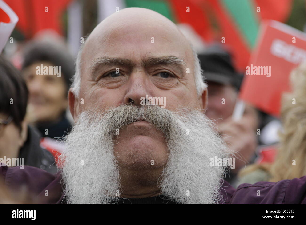 Sofia, Bulgarie. 17 novembre 2012. Homme avec big moustache dans la foule  des manifestants anti-austérité, Parti socialiste bulgare et de drapeaux à l'arrière-plan.  Plusieurs étaient de vieux drapeaux de parti communiste de