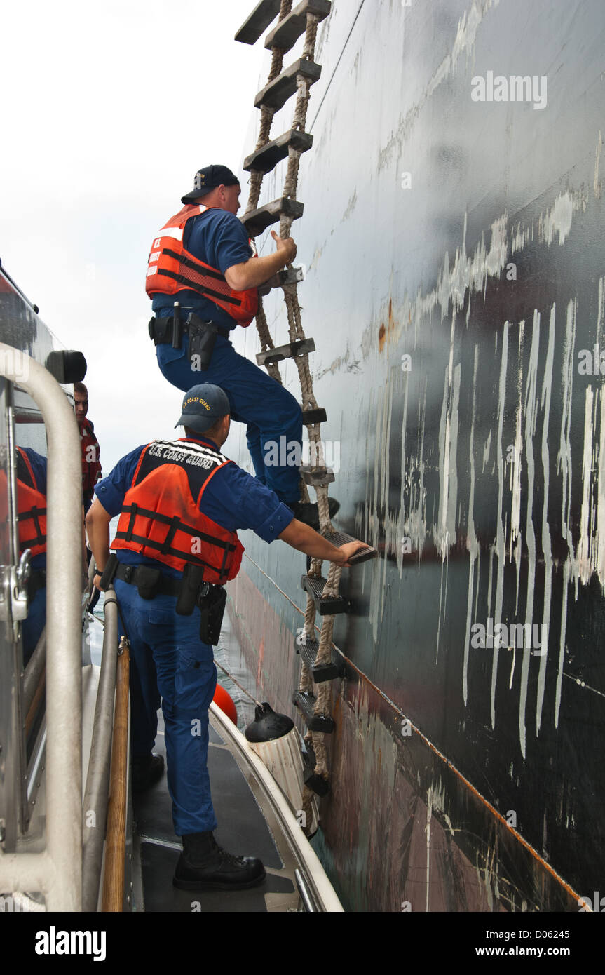 Les agents de la Garde côtière américaine échelle de corde de montée à bord d'un navire-citerne, Port Aransas Texas Banque D'Images