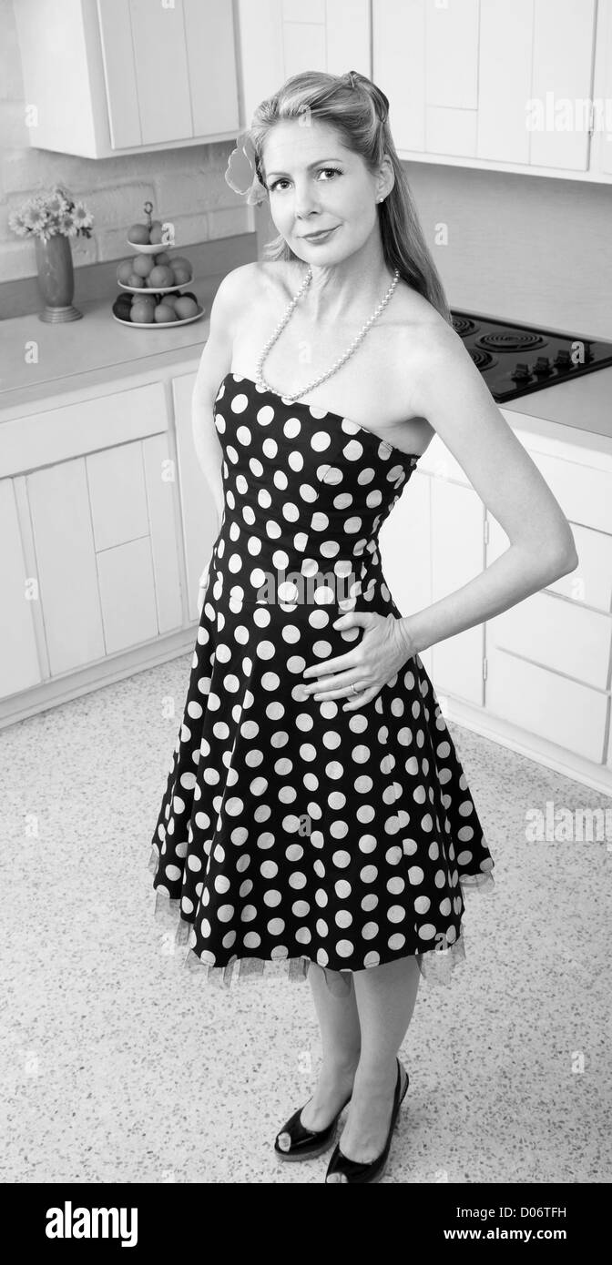 Belle Caucasian woman with hands on hips in kitchen Banque D'Images