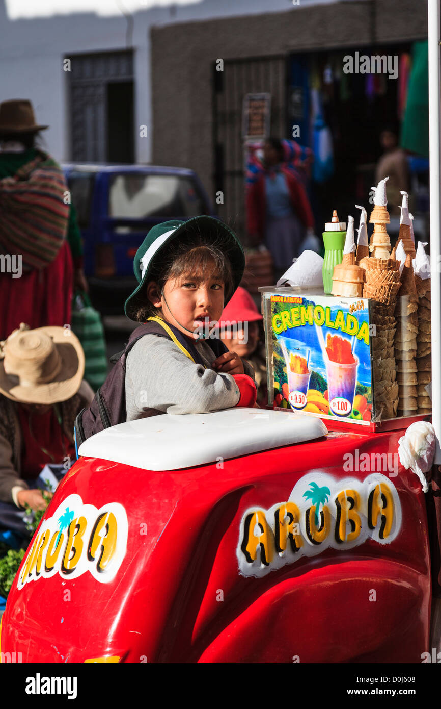 Jeune garçon l'achat de glace dans la rue du marché, Cuzco, Pérou Banque D'Images
