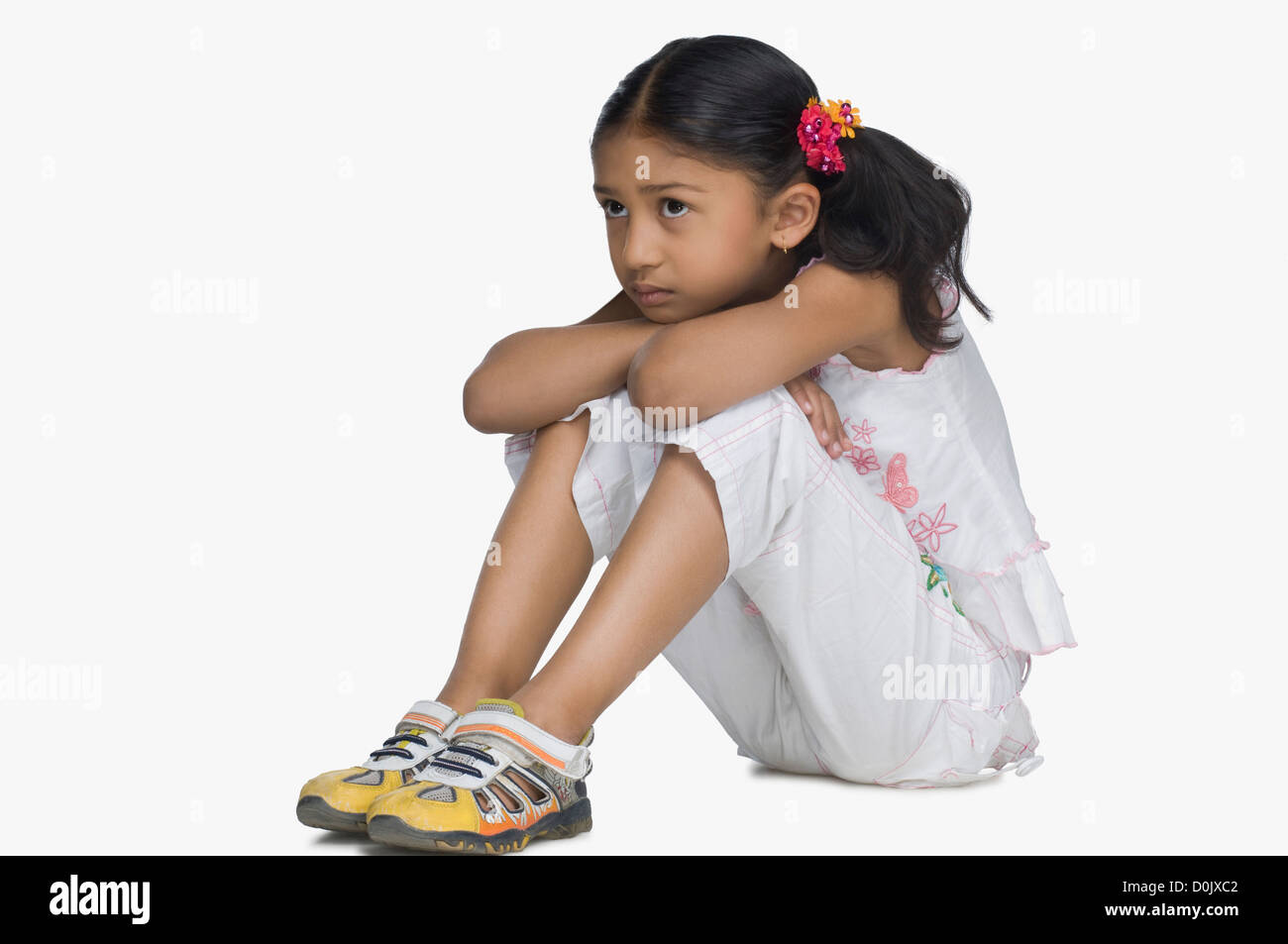 Girl resting son visage sur ses genoux Banque D'Images