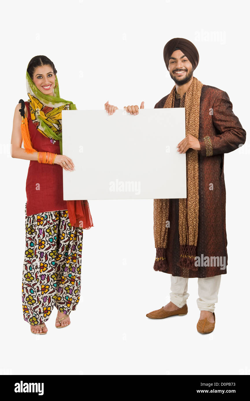 Portrait d'un Sikh couple holding a blank placard Banque D'Images