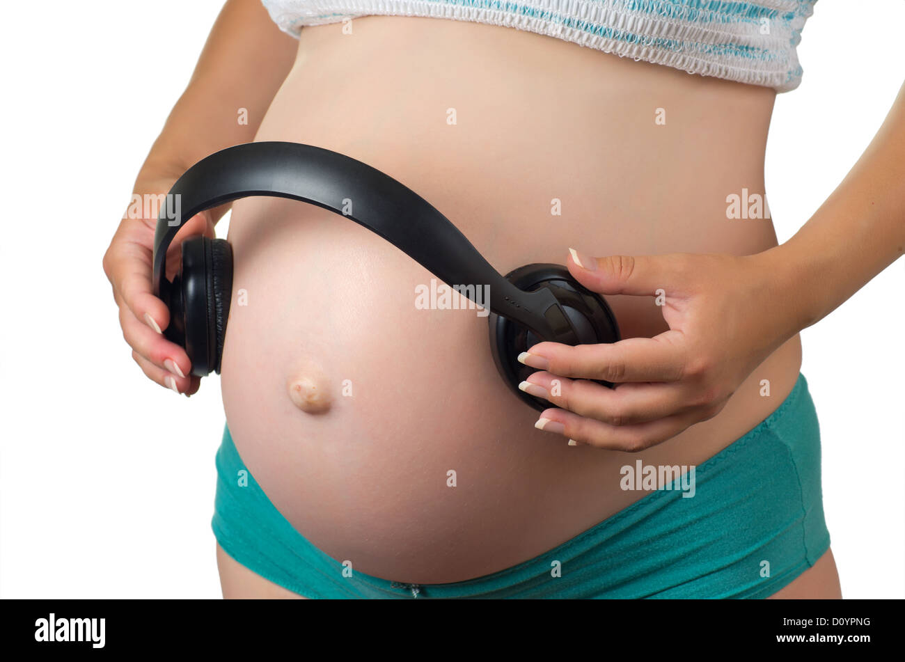 Ventre d'une femme enceinte avec un casque Photo Stock - Alamy