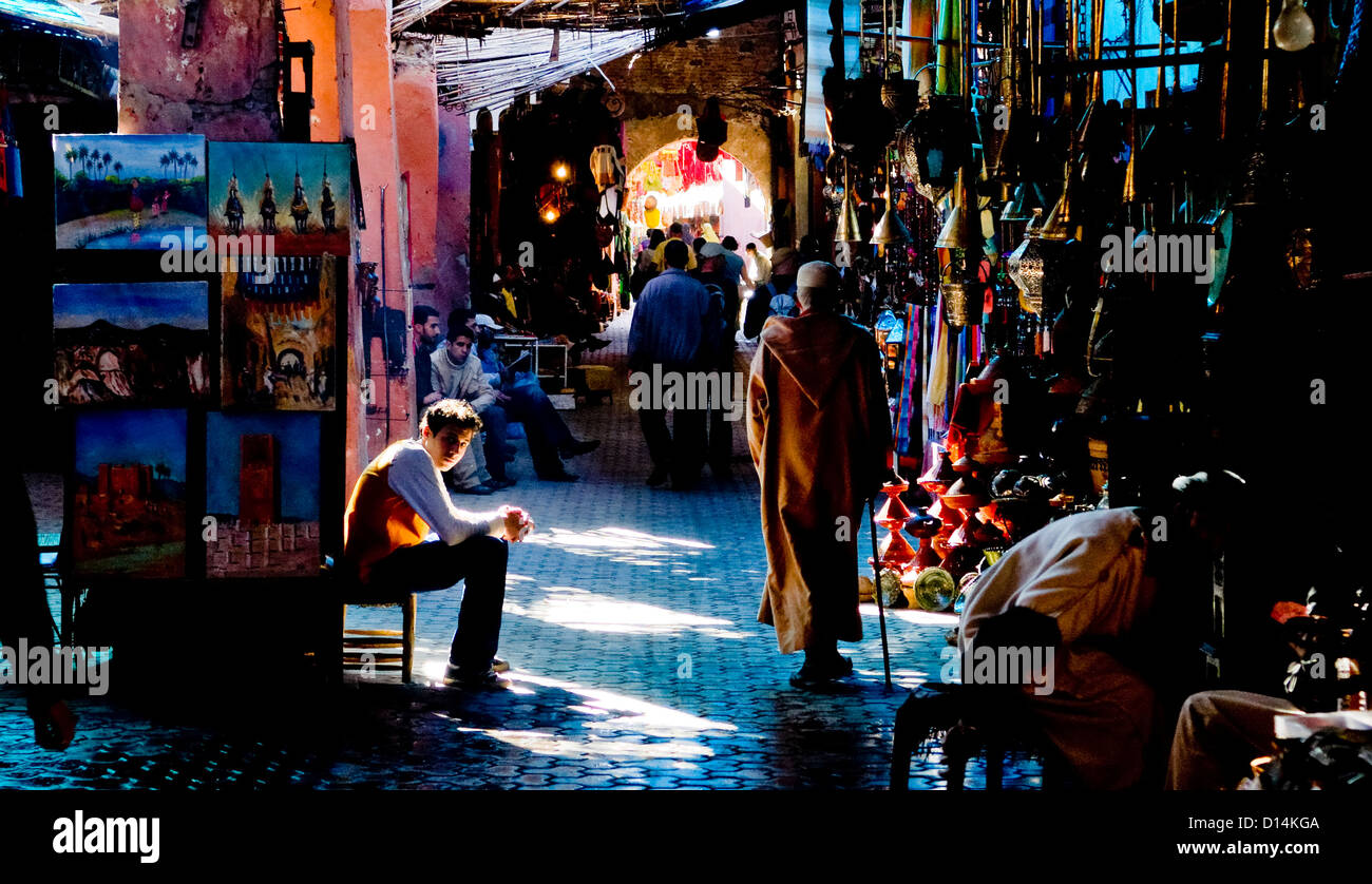 Peintures et autres souvenirs en vente dans les ombres sur le souk, à Marrakech, Maroc Banque D'Images
